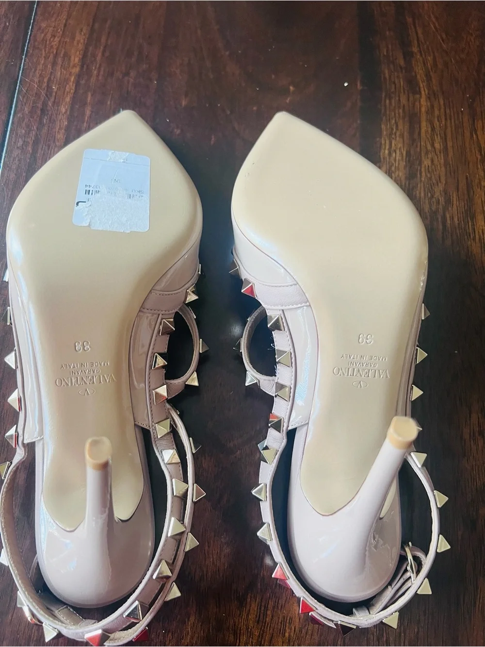 Valentino Garavani patent nappa leather pump feature iconic platinum-finish stud